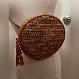 Brown circular belt bag, vegan leather and textured woven.